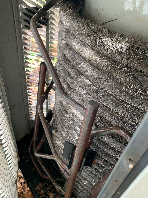 Completed cooling system tune-up on 2005 AC unit, performing standard maintenance protocol including inspection of evaporator coil, refrigerant lines, electrical connections, and air filters. Noted previous gas leak issue addressed by utility company and identified unsealed opening in basement brick wall where furnace and water heater flue penetrates, recommending proper sealing to prevent air infiltration and maintain building envelope integrity. All cooling system components operating within normal parameters upon completion of service.