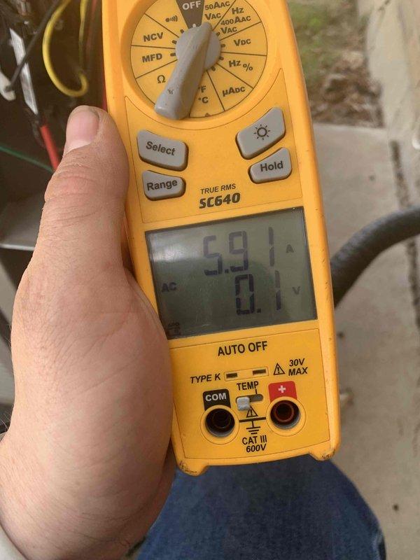 Returned to property to confirm location of refrigerant leak as previously identified during maintenance visit. Performed diagnostic testing using digital multimeter to check electrical readings and system performance. Measured amperage draw at 1.52A and voltage readings, then conducted follow-up measurements showing 5.91A draw to verify compressor and system operation. Confirmed leak location and documented findings for repair quote preparation.