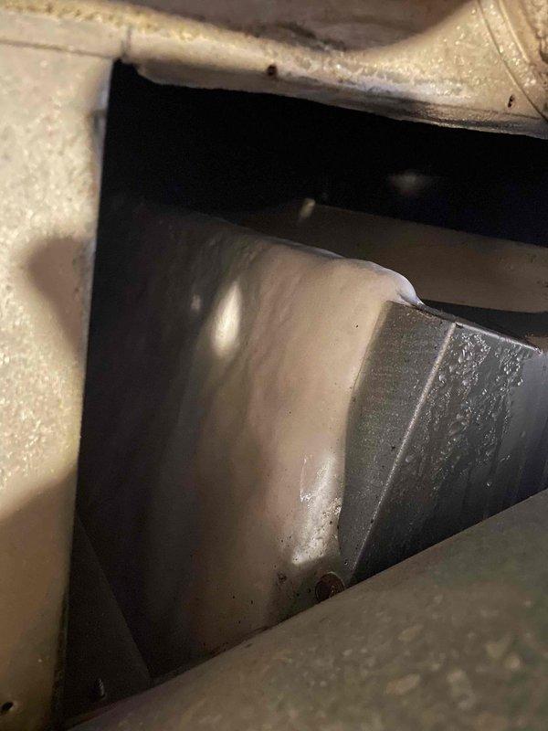 Responded to callback for reported AC leak that could not be previously replicated due to weather conditions. Upon arrival, accessed air handler unit located at rear of home and inspected system during active cooling operation. Found significant condensation accumulation on supply plenum and flex ductwork in attic space, with water droplets visible on metal surfaces and duct insulation. Identified condensation as source of reported leak rather than refrigerant or drain line issue. Verified drain pan and condensate line were clear and functioning properly. System operating within normal parameters with adequate airflow through blower assembly.