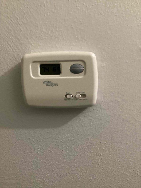 Responded to reported water leak from furnace in basement with rust present and wet filter condition. Performed diagnostic inspection of HVAC system including basement furnace unit and outdoor condenser. AC unit confirmed to be cooling properly at time of service, with outdoor condenser operating normally and positioned on concrete pad with adequate clearance. Documented existing thermostat configuration and system controls for service records.