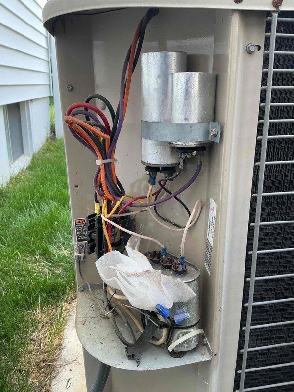 Completed comprehensive air conditioning tune-up and maintenance on single outdoor condensing unit located on side of residence. Performed visual inspection of all accessible components including capacitor, electrical connections, and condenser coil; verified all wiring connections were secure with proper bundling; inspected condensate drain assembly for proper operation; examined condenser coil fins for debris and damage; confirmed unit mounted securely on concrete pad with adequate clearance. System found in good operating condition with all components functioning properly and no immediate service needs identified.