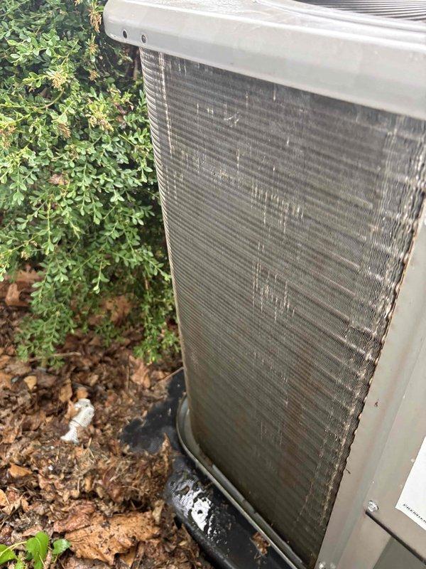 Responded to no cooling call on residential air conditioning system. Upon arrival, found outdoor condenser unit with heavily soiled coil fins showing significant dirt and debris accumulation, restricting airflow. Indoor air handler exhibited extensive age-related deterioration with corroded galvanized metal panels. Performed diagnostic evaluation of system components and confirmed operational status. Condenser coil cleaning was necessary due to substantial environmental contamination affecting heat transfer efficiency. System restored to proper cooling operation following service intervention.