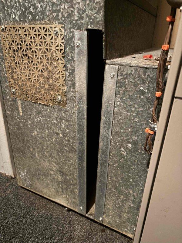 Responded to no cooling call on residential air conditioning system. Upon arrival, found outdoor condenser unit with heavily soiled coil fins showing significant dirt and debris accumulation, restricting airflow. Indoor air handler exhibited extensive age-related deterioration with corroded galvanized metal panels. Performed diagnostic evaluation of system components and confirmed operational status. Condenser coil cleaning was necessary due to substantial environmental contamination affecting heat transfer efficiency. System restored to proper cooling operation following service intervention.