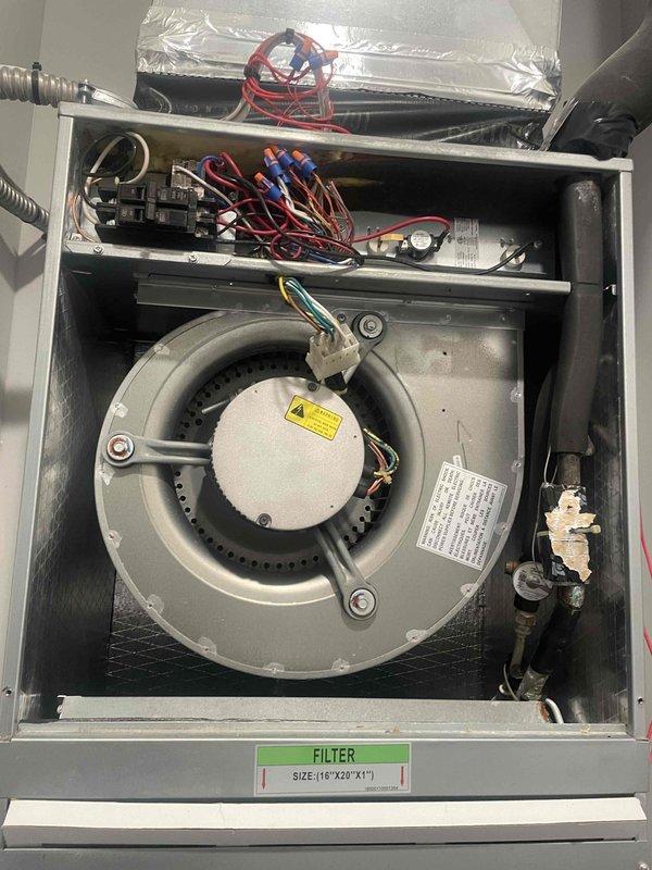 Responded to no cooling call with reported indoor fan not blowing on U10 system located in closet. Upon inspection, accessed blower compartment and identified issue with blower motor assembly on Goodman FMAX1800AL1 unit (208/230V, 1/3 HP motor, R410A refrigerant). Photographed blower motor installation, electrical connections, and unit specifications for documentation. Evaluated motor operation, wiring connections including red, blue, and black wire bundles, and circuit breaker panel. Verified unit nameplate data and filter specifications (16"x20"x1"). System requires motor replacement or repair to restore proper indoor air circulation and cooling function.