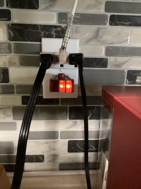 # Electrical Maintenance - Home Audit

Conducted a complimentary electrical safety inspection of residential premises, examining outlet conditions, wiring connections, and LED lighting installations. Documented kitchen backsplash outlet with illuminated indicator light and power cord connections, as well as garage LED strip lighting installation with visible wiring along wall-ceiling junction. All observed electrical components were photographed for record-keeping purposes.