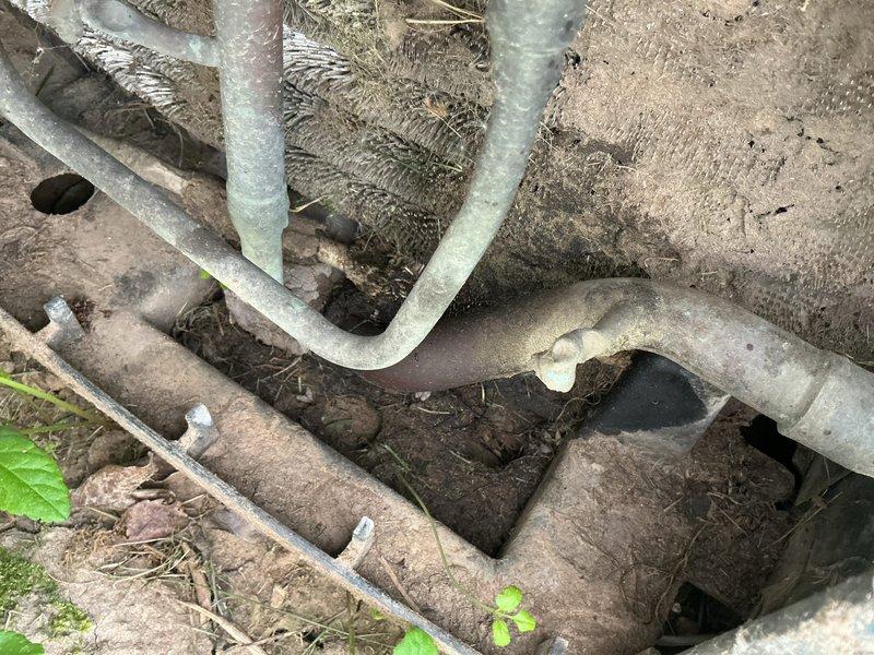 Responded to no cooling call on 16-year-old residential air conditioning system. Upon arrival, confirmed blower motor operating but unit delivering warm air and running continuously without reaching setpoint. Performed diagnostic evaluation of outdoor condensing unit and indoor air handler components. Inspected refrigerant lines, electrical connections, and compressor operation. Documented equipment condition with photographs showing outdoor condenser unit installation and associated piping configuration. Identified system malfunction and provided customer with repair recommendations to restore cooling capacity.