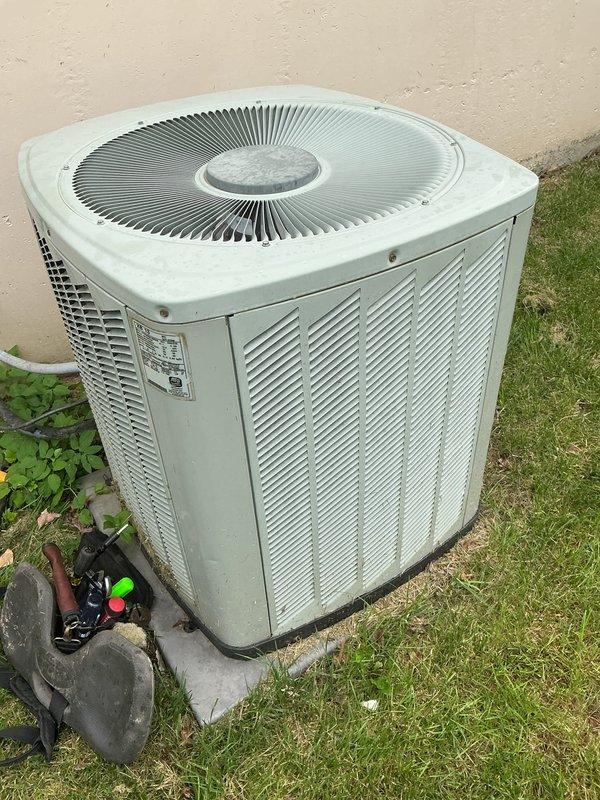 Responded to no cooling call on 16-year-old residential air conditioning system. Upon arrival, confirmed blower motor operating but unit delivering warm air and running continuously without reaching setpoint. Performed diagnostic evaluation of outdoor condensing unit and indoor air handler components. Inspected refrigerant lines, electrical connections, and compressor operation. Documented equipment condition with photographs showing outdoor condenser unit installation and associated piping configuration. Identified system malfunction and provided customer with repair recommendations to restore cooling capacity.