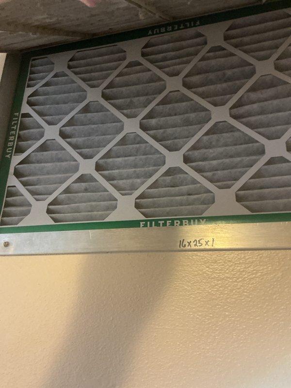 Completed comprehensive air conditioning tune-up service on single residential unit located near washroom area. Performed standard maintenance inspection including evaluation of control board assembly, electrical connections, and system components. Inspected and documented condition of 16x25x1 air filter showing moderate dust accumulation, examined circuit board with relay controls and verified all wire connections and safety warning labels were intact and functional.