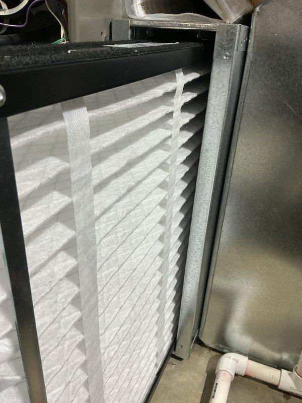 Replaced drain trap assembly on HVAC system and performed preventative maintenance safety check (PSCC). Verified thermostat operation showing proper temperature readings and inspected air filtration system with pleated filter in place. All components tested and confirmed operational for both heating and cooling modes.