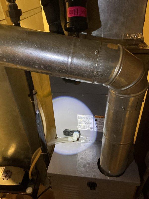 Responded to callback for water leakage around furnace following evaporator coil replacement completed on 4/9. Upon arrival, inspected HVAC system in basement and identified condensate drainage issue related to previous coil installation. Verified condensate drain line connections, cleared any blockages, and ensured proper pitch for gravity drainage. Checked condensate trap assembly for proper installation and water seal. Tested system operation to confirm water is draining correctly through primary drain line without pooling on floor. Cleaned up residual water around furnace base and verified no active leaks present. System operating normally with no further water accumulation observed.