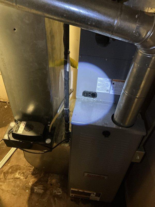 Responded to callback for water leakage around furnace following evaporator coil replacement completed on 4/9. Upon arrival, inspected HVAC system in basement and identified condensate drainage issue related to previous coil installation. Verified condensate drain line connections, cleared any blockages, and ensured proper pitch for gravity drainage. Checked condensate trap assembly for proper installation and water seal. Tested system operation to confirm water is draining correctly through primary drain line without pooling on floor. Cleaned up residual water around furnace base and verified no active leaks present. System operating normally with no further water accumulation observed.