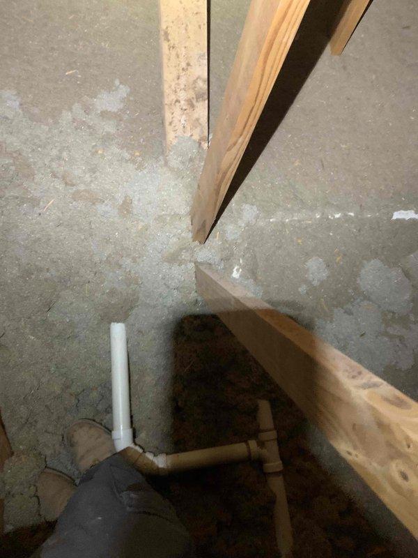 Removed existing PVC drain lines and water supply lines from original kitchen configuration. Re-routed 2-inch PVC drain piping and 1/2-inch water supply lines through basement ceiling joists to new island location, securing all lines per code requirements. Installed new loop vent system within the island hip wall to provide proper drainage venting for the relocated fixtures. Completed rough-in plumbing for kitchen sink drain and supply connections, dishwasher drain and supply hook-ups, and refrigerator water supply line at new designated locations. All piping installations positioned and ready for finish connections once cabinetry and appliances are set in place.