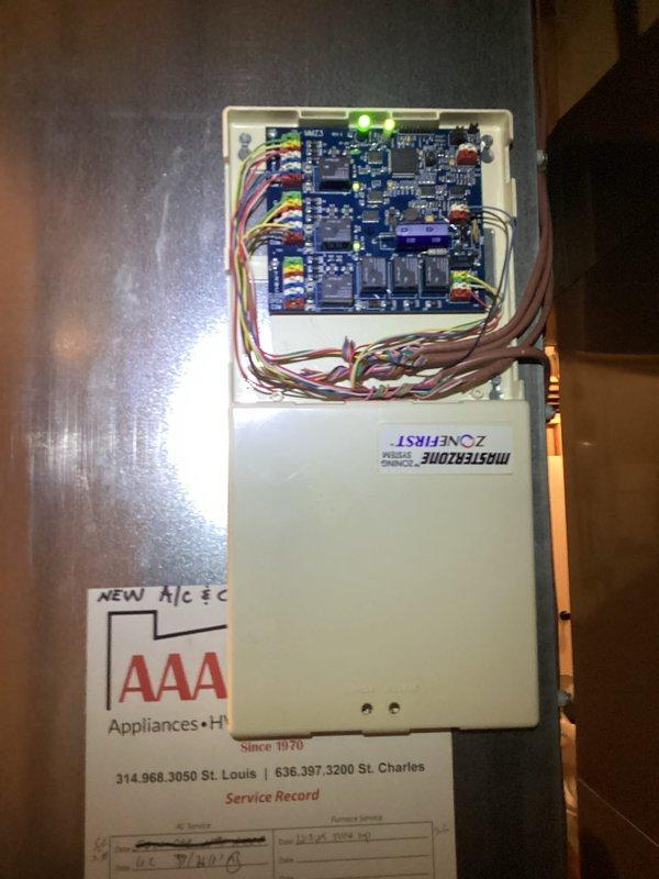 # HVAC Zoning System Damper Noise Diagnosis and Inspection

Responded to customer report of noise originating from damper system. Performed comprehensive inspection of HVAC zoning control system including ZoneFirst control panel with dual circuit boards and associated wiring connections. Verified all electrical connections at terminal blocks and examined control board functionality. Inspected damper actuators and mechanical components throughout ductwork system in attic space. Examined main supply plenum, branch ductwork, and damper assemblies for proper operation and potential noise sources. Checked refrigerant lines, mechanical supports, and duct mounting hardware for secure installation. Tested zone control system operation through multiple cycles to identify intermittent noise conditions. Documented system configuration and current operating conditions with photographic records. System zoning controls and damper mechanisms assessed for proper functionality and noise mitigation requ