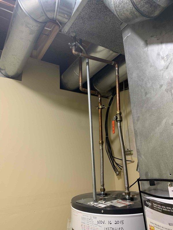 Installed a 50-gallon electric tall water heater in basement utility room. Relocated existing utility sink to accommodate proper placement and clearance requirements for new water heater installation. Connected all water supply lines, electrical connections, and pressure relief valve per manufacturer specifications and local code requirements.