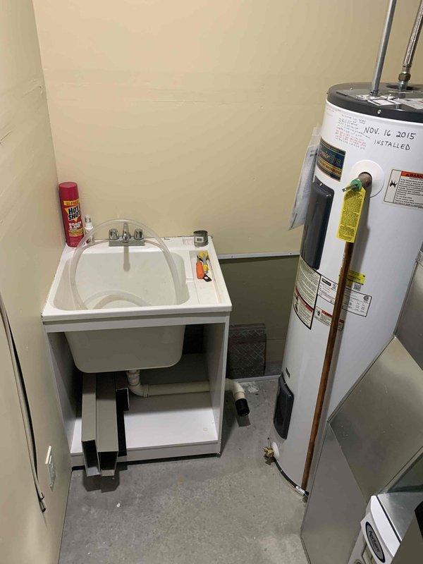 Installed a 50-gallon electric tall water heater in basement utility room. Relocated existing utility sink to accommodate proper placement and clearance requirements for new water heater installation. Connected all water supply lines, electrical connections, and pressure relief valve per manufacturer specifications and local code requirements.