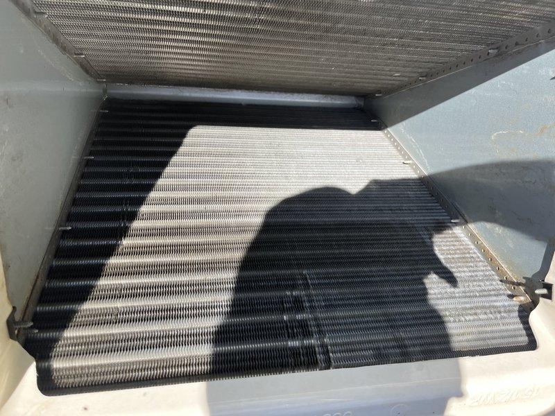 Removed evaporator coil from HVAC unit for thorough external cleaning due to significant dirt and debris accumulation affecting approximately two-thirds of the coil surface. The coil exhibited heavy blackened discoloration and grime buildup that was restricting proper airflow and heat exchange efficiency. After cleaning, reinstalled the evaporator coil and restored unit to proper operating condition.