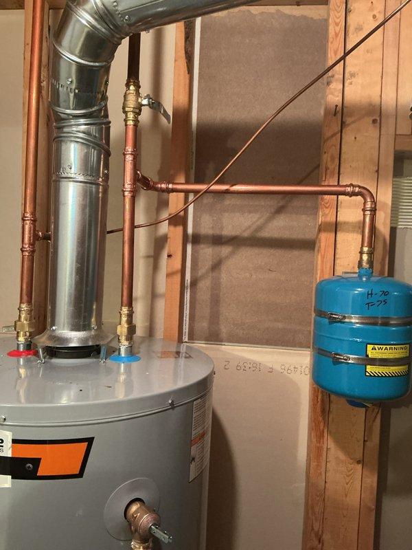 Installed a 50-gallon tall gas water heater in the walkout basement, connecting copper supply lines with shutoff valves and installing a blue expansion tank mounted to the wall framing. Configured the galvanized flue vent system extending from the top of the State brand unit and completed all connections per manufacturer specifications and local code requirements. All components were tested and verified operational upon completion of the installation.