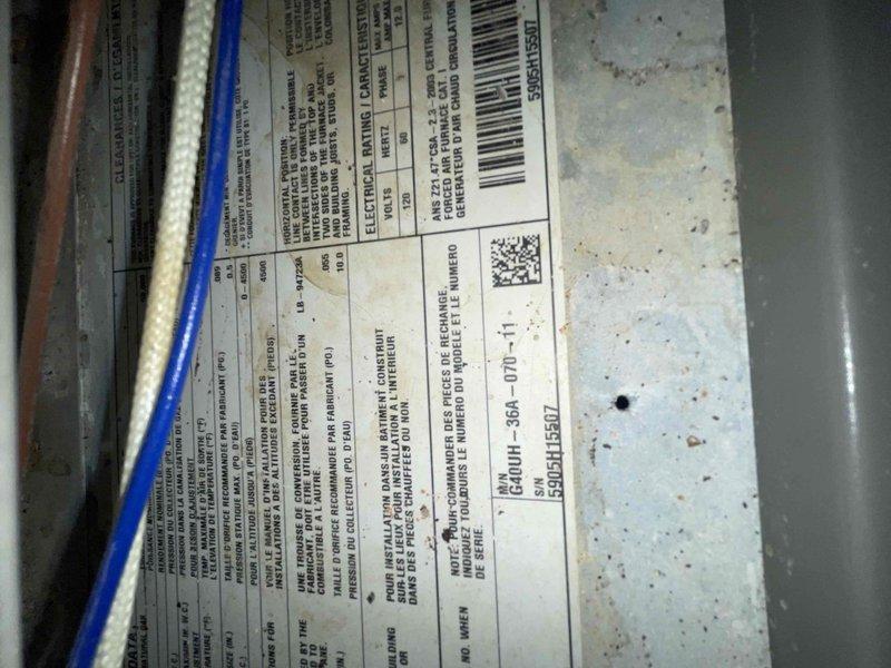 Responded to no cooling call on 10+ year old second floor system with frozen refrigerant line at condenser. Upon inspection, found restricted airflow at air handler due to excessive dust accumulation on blower wheel and housing of GCUH-36A-070 unit. Cleaned blower assembly, verified motor operation, and restored proper system airflow to resolve freezing condition.