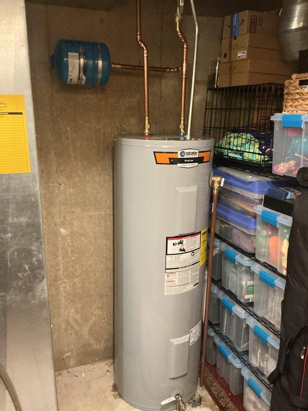 Installed a 50-gallon tall electric water heater in basement utility area with 3/4-inch pressure reducing valve. Connected copper supply lines with brass fittings to existing plumbing infrastructure and verified proper operation of all components. Payment collected cash on delivery.