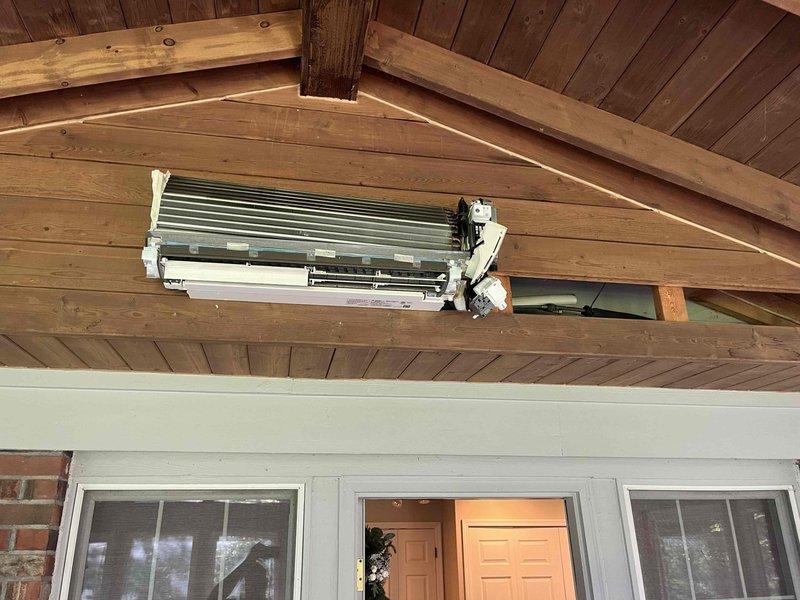 Replaced defective evaporator coil on wall-mounted ductless mini-split air conditioning unit under warranty coverage. Removed front access panel to access internal components, disconnected electrical connections and refrigerant lines, extracted failed evaporator coil assembly (S/N 6009299T), and installed new replacement unit. Reconnected all wiring, secured motor assembly and mounting brackets, verified proper installation of heat exchanger fins, reassembled unit housing, and confirmed system operational status with heat and cool functionality tested successfully.