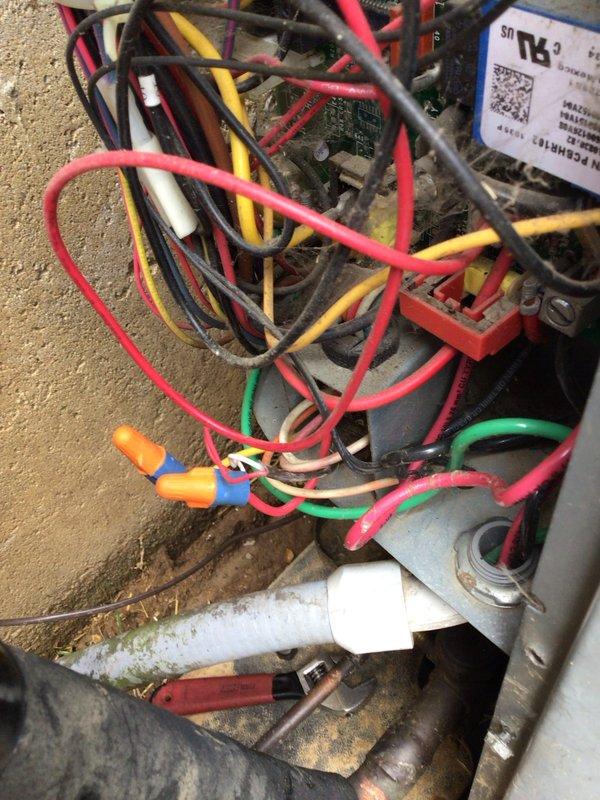 # HVAC Service Report - No Cooling Issue

Responded to service call for air conditioning system not providing adequate cooling. Unit is a 16-year-old outdoor condenser that has reached the latter stage of its expected service life.

Upon arrival, performed comprehensive system diagnostic to identify root cause of cooling failure. Conducted visual inspection of outdoor condenser unit, noting overall age-related wear consistent with 16 years of operation. Removed access panels to examine internal components, wiring connections, and electrical systems.

Inspected control board and electrical connections within the unit, documenting the condition of multi-colored wiring harnesses including power supply lines, control wiring, and safety circuits. Verified integrity of wire connections and splice points, checking for loose connections, corrosion, or heat damage that could affect system performance.

Examined condensate drainage system including PVC piping for proper flow and potential blocka