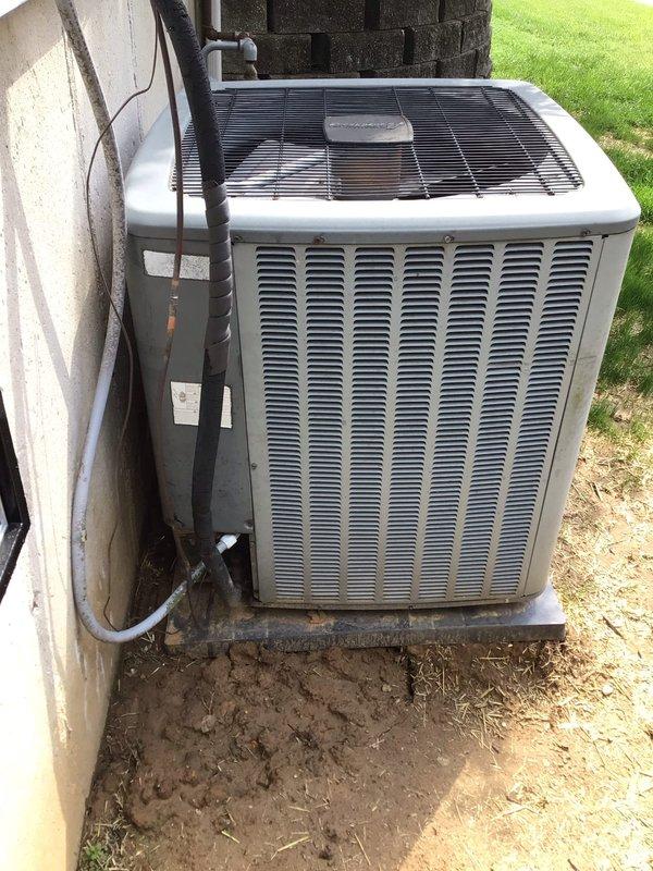 # HVAC Service Report - No Cooling Issue

Responded to service call for air conditioning system not providing adequate cooling. Unit is a 16-year-old outdoor condenser that has reached the latter stage of its expected service life.

Upon arrival, performed comprehensive system diagnostic to identify root cause of cooling failure. Conducted visual inspection of outdoor condenser unit, noting overall age-related wear consistent with 16 years of operation. Removed access panels to examine internal components, wiring connections, and electrical systems.

Inspected control board and electrical connections within the unit, documenting the condition of multi-colored wiring harnesses including power supply lines, control wiring, and safety circuits. Verified integrity of wire connections and splice points, checking for loose connections, corrosion, or heat damage that could affect system performance.

Examined condensate drainage system including PVC piping for proper flow and potential blocka