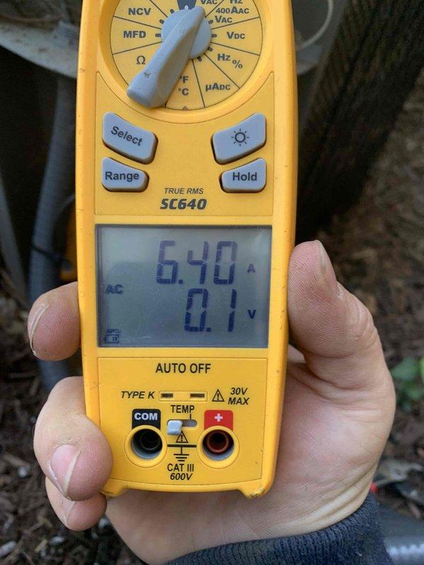 Completed comprehensive spring tune-up on residential air conditioning system. Performed full system inspection including electrical measurements with digital multimeter, verified proper amperage draw and voltage levels at outdoor condensing unit. Unit located on exterior wall with adequate clearance and wood chip mulch base for drainage. All components operating within normal parameters with no deficiencies noted during inspection.