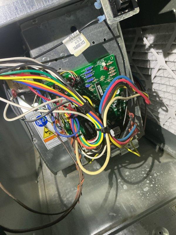 Responded to no cooling complaint on residential HVAC system that was running continuously without achieving temperature setpoint. Upon arrival, performed diagnostic evaluation of system components including control board, wiring connections, and blower assembly. Inspected electrical connections at circuit board, verified proper wire terminations, and assessed overall system operation. Documented equipment condition with interior control panel and return air grill photographs showing typical wear and environmental accumulation. Identified issues preventing proper cooling cycle and provided recommendations for necessary repairs to restore normal system function.