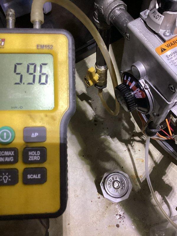 Responded to callback for pilot light issues on recently installed water heater. Upon arrival, performed comprehensive diagnostic testing of gas supply system using digital manometer. Measured gas pressure at multiple points including inlet and manifold pressure to verify proper gas flow to pilot assembly. Initial reading showed 36.9 units at supply line, with manifold pressure measuring 5.96 inches water column. Inspected gas valve assembly, pilot generator, and thermocouple connections for proper installation and functionality. Verified all brass fittings were secure and flexible gas line connections were properly tightened to manufacturer specifications. Checked pressure relief valve installation and copper piping connections at top of tank. Examined pilot assembly components including igniter electrode gap and flame sensor positioning. Adjusted gas pressure regulator to ensure optimal performance within manufacturer's specified range. Tested pilot ignition sequence multiple times t