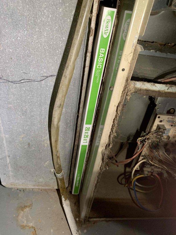 Completed comprehensive cooling system tune-up on 23-year-old residential air conditioning unit located on side of home. System inspection revealed significant dust and debris accumulation on evaporator coil fins and collection pan filled with organic matter including leaves and plant material. Performed standard maintenance procedures including cleaning of coil assembly, removal of debris from drain pan, inspection of refrigerant lines and electrical connections, and verification of proper system operation.