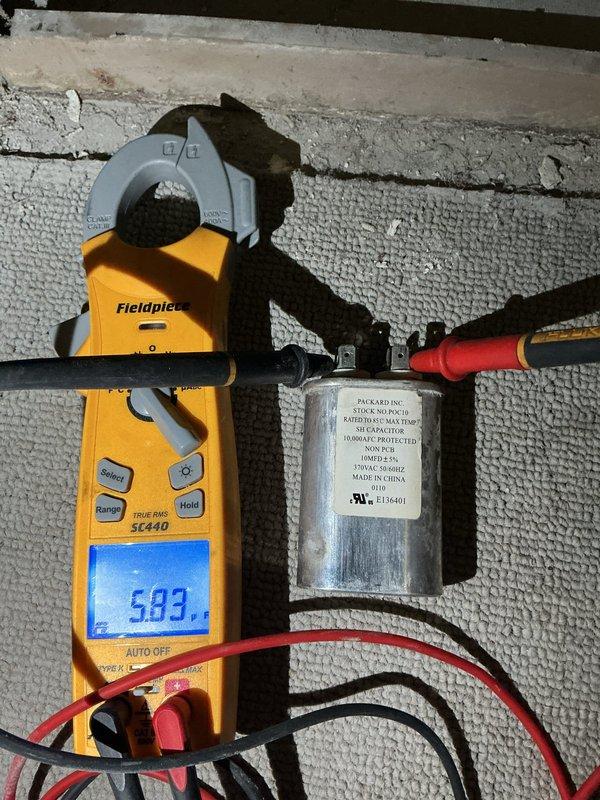 Replaced failed blower motor capacitor on PEA-3 unit with new Packard capacitor from truck stock. Verified proper electrical readings of 583 microfarads using clamp meter after installation, confirming system returned to normal operation with heating and cooling functionality restored.