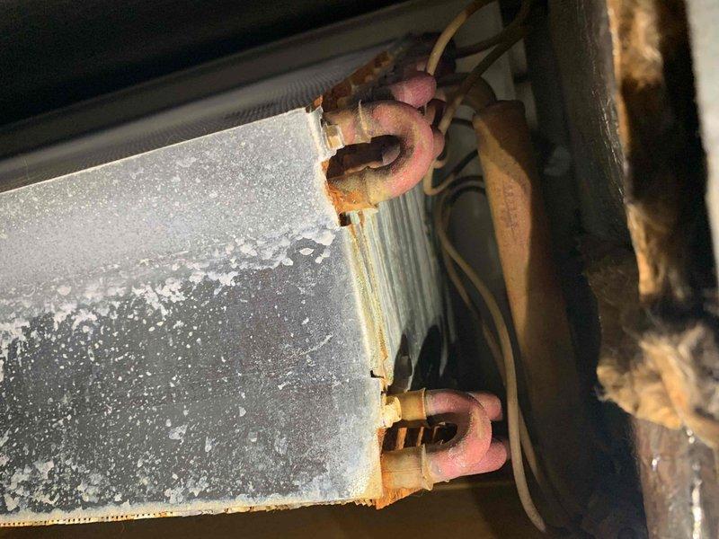 # HVAC Cooling System Tune-Up - Two Units

Completed comprehensive preventive maintenance tune-up on two residential air conditioning systems per U10 protocol. One unit located on exterior pad, second unit in attic space. Both systems under ten years of age.

## Work Performed

Conducted full system inspections on both cooling units including visual assessment of all major components. Measured and recorded electrical parameters using digital multimeter, verifying amperage draw and voltage levels within manufacturer specifications. Current draw measured at 4.12 amps with 0.1 volts displayed during diagnostic testing.

Inspected evaporator coils on both systems, noting accumulated dust and debris on coil fins requiring attention during routine maintenance cycle. Examined refrigerant line sets, observing significant deterioration of pink foam insulation sleeves with exposed sections showing wear and fragmentation. Copper refrigerant lines displayed moderate to heavy surface oxidation and 