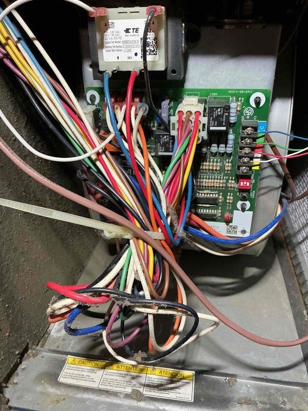 Completed preventive maintenance tune-up on a 10-year-old Goodman air conditioning system. Inspected outdoor condensing unit, verified proper airflow through grille assembly, and examined internal control panel wiring connections and circuit board components. All electrical connections, relay operation, and safety labels were checked and found to be in satisfactory working condition.