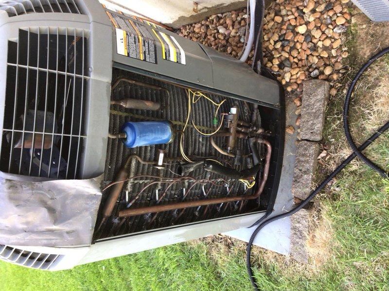 # HVAC Cooling System Tune-Up

Performed comprehensive preventive maintenance service on a 17-year-old residential air conditioning unit located outdoors. Conducted complete system inspection including examination of the blower motor assembly, electrical connections, and capacitor. Evaluated condenser coil condition, noting accumulated debris and dust on fins requiring attention for optimal heat transfer efficiency. Verified all wire connections at motor terminal points, inspected mounting hardware and brackets for secure installation, and assessed overall component condition. Documented system condition through photographic records showing blower assembly with color-coded wiring harnesses and outdoor condenser unit with exposed internal components including dual coil banks, capacitor, and refrigerant lines.