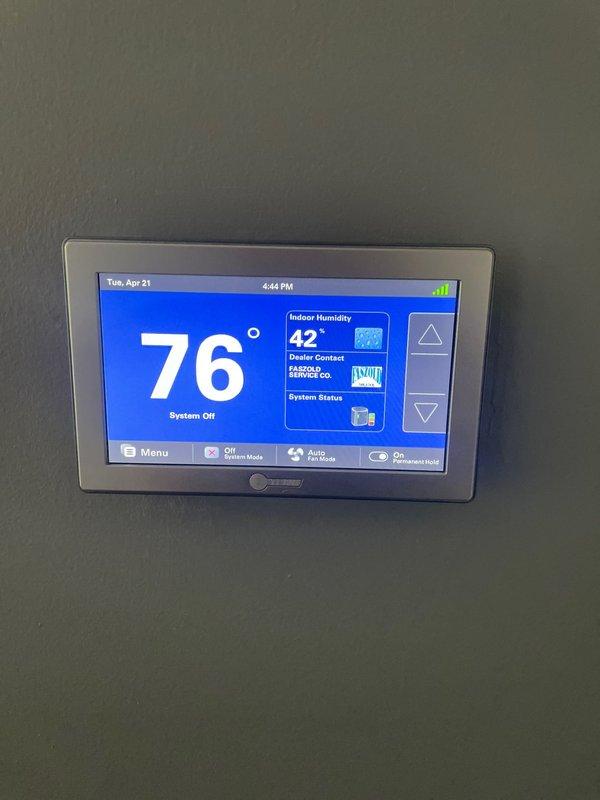 Responded to service call for non-responsive AC control panel with remote and zone sensor communication issues. Performed comprehensive diagnostic troubleshooting of the zoned HVAC system including inspection of the digital touchscreen thermostat, air handler unit, and associated wiring connections. Verified proper power supply to control panels, checked sensor communication pathways, and examined the zone control system components in the mechanical room. System was found in "Off" mode during inspection; confirmed thermostat display functionality and dealer contact information properly programmed into the interface.