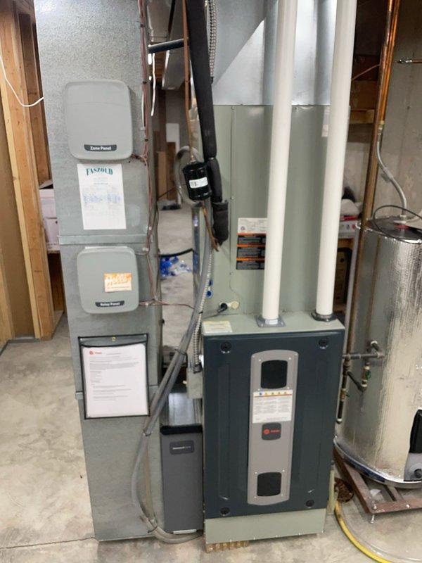 Responded to service call for non-responsive AC control panel with remote and zone sensor communication issues. Performed comprehensive diagnostic troubleshooting of the zoned HVAC system including inspection of the digital touchscreen thermostat, air handler unit, and associated wiring connections. Verified proper power supply to control panels, checked sensor communication pathways, and examined the zone control system components in the mechanical room. System was found in "Off" mode during inspection; confirmed thermostat display functionality and dealer contact information properly programmed into the interface.