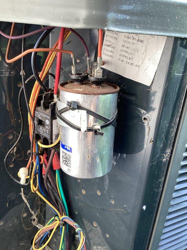 Completed scheduled cooling maintenance on 9-year-old Trane air conditioning system. Performed comprehensive AC tune-up including visual inspection of electrical components, capacitor assessment, and system operational verification. Inspected dual-run capacitor showing signs of age with surface corrosion and discoloration; capacitor tested within acceptable parameters and remains functional. Checked all electrical connections, contactor operation, and wiring integrity. System operating properly at time of service completion.
