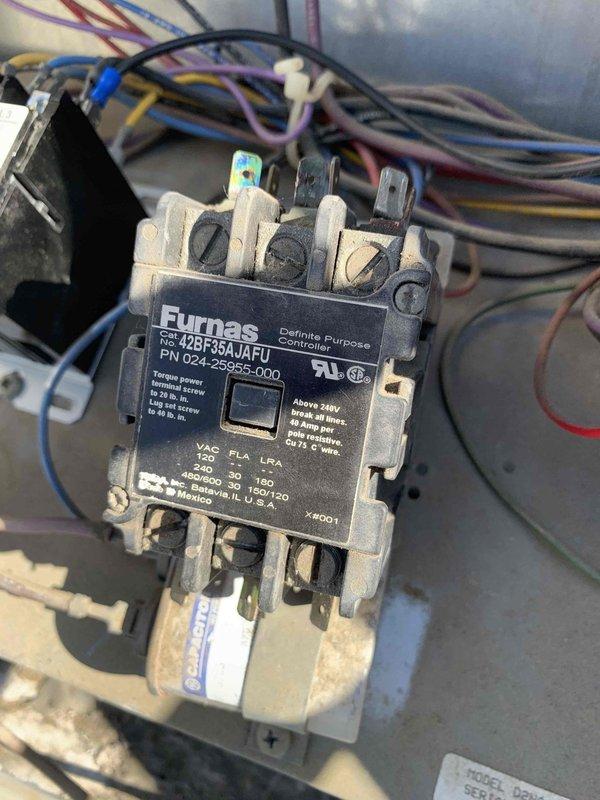 Replaced failed Furnas electrical contactor with new Packard C330A 3-pole contactor rated for 208/240V operation. Transferred all electrical connections from old unit to new contactor, verifying proper wire terminations at L1, L2, L3 line terminals and T1, T2 load terminals. System tested and confirmed operational for both heating and cooling modes.