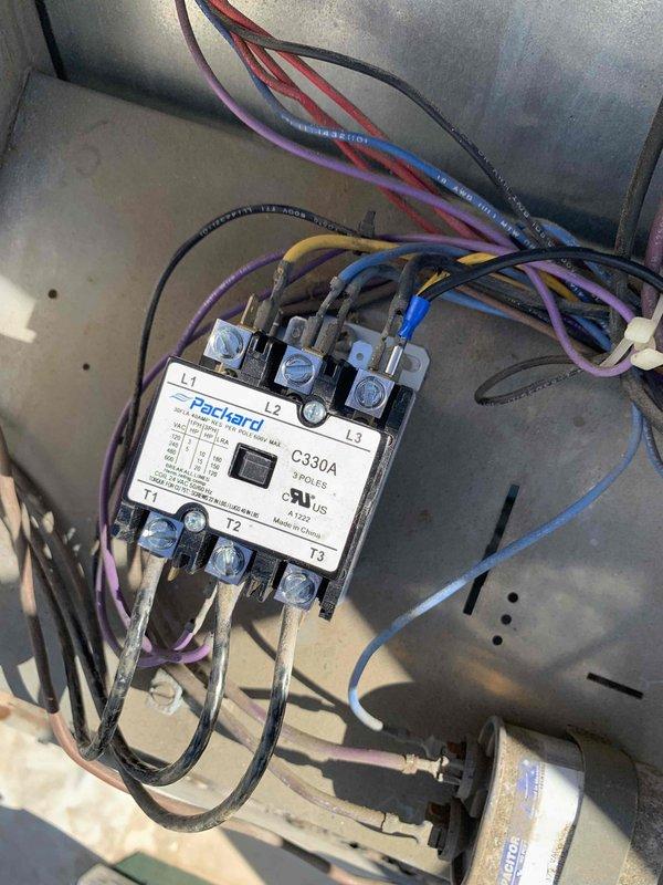 Replaced failed Furnas electrical contactor with new Packard C330A 3-pole contactor rated for 208/240V operation. Transferred all electrical connections from old unit to new contactor, verifying proper wire terminations at L1, L2, L3 line terminals and T1, T2 load terminals. System tested and confirmed operational for both heating and cooling modes.
