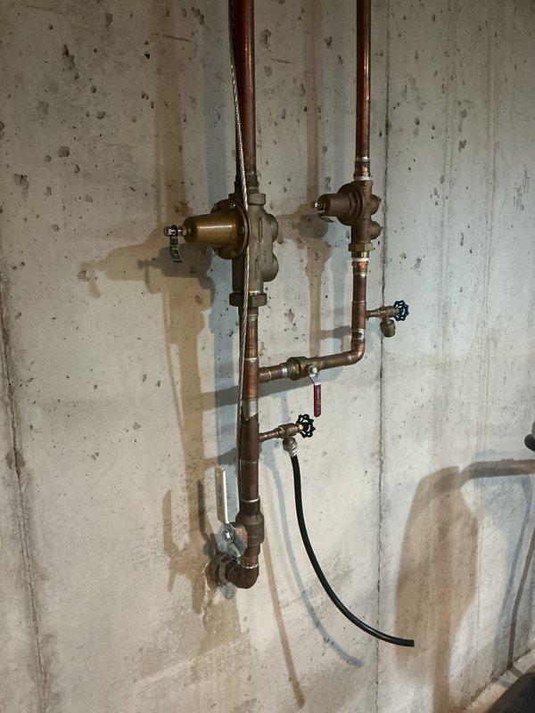 Completed installation of 50-gallon tall gas water heater with proper expansion tank and pressure regulation components. Configured copper supply and distribution piping with brass fittings, shut-off valves, and safety equipment per code requirements. Installation performed under permit #26PLU-07657 with required plumbing identification sticker applied to unit.