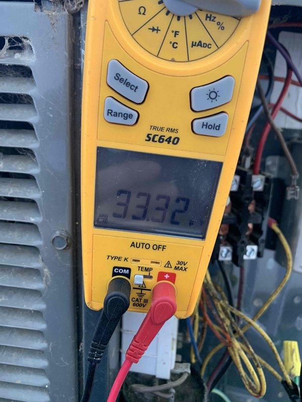 Completed comprehensive tune-up on a 10-year-old residential air conditioning unit located in backyard. Performed standard maintenance protocol including electrical diagnostics using digital multimeter, recording voltage readings of 33.32V and 11.13V at various system points to verify proper electrical operation and component functionality. All measurements fell within acceptable parameters, system operating efficiently with no issues identified.