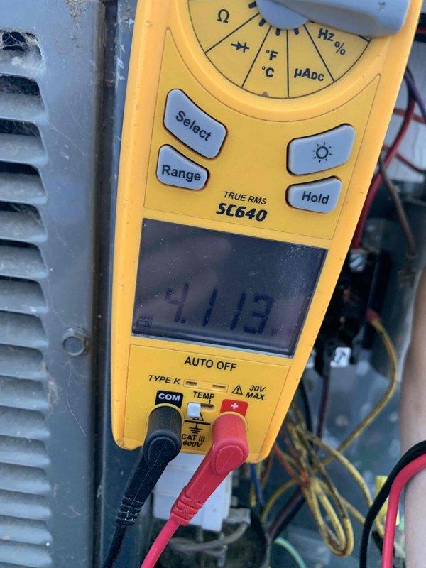 Completed comprehensive tune-up on a 10-year-old residential air conditioning unit located in backyard. Performed standard maintenance protocol including electrical diagnostics using digital multimeter, recording voltage readings of 33.32V and 11.13V at various system points to verify proper electrical operation and component functionality. All measurements fell within acceptable parameters, system operating efficiently with no issues identified.
