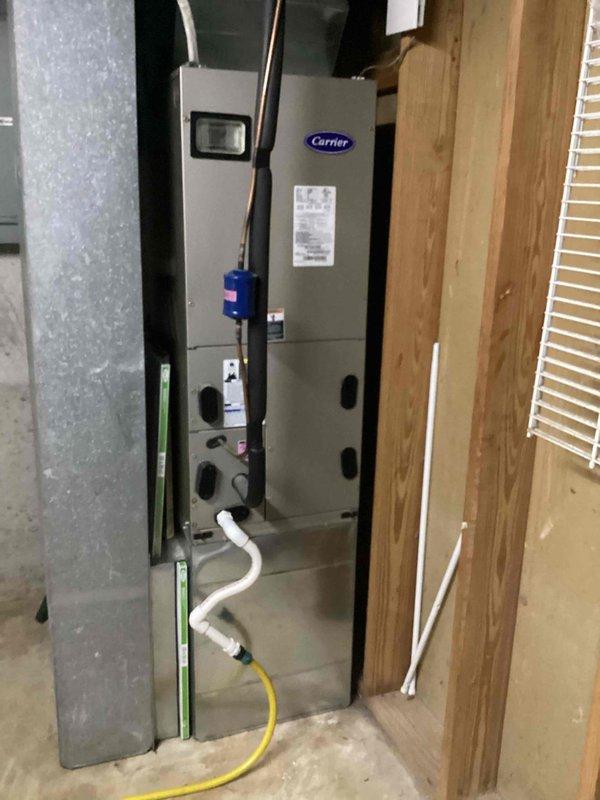 Responded to no cooling complaint on 10+ year old Carrier air handler unit located at ground level on side of home. Upon inspection, found blower motor issue preventing proper airflow through system. Accessed interior compartment and inspected electrical connections, wiring harness, and blower assembly. Verified all wire connections at junction box were secure and tested motor capacitor and relay components. Restored proper blower operation and confirmed adequate airflow throughout system. Unit cooling normally at time of departure.