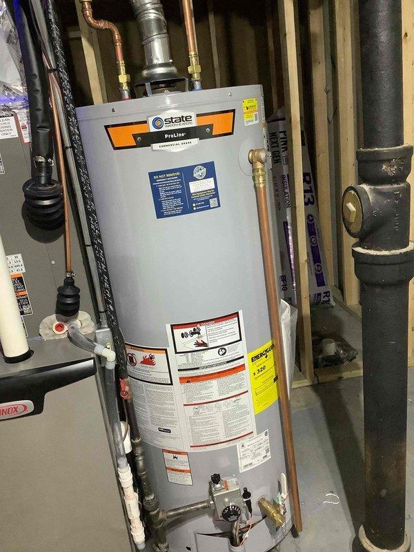 Installed 50-gallon State ProLine gas water heater as part of full system installation under permit #26PLU-07650. Completed all copper supply line connections, integrated water treatment system with blue filter housing, and installed required safety components including pressure relief valve and gas supply connections. Applied required plumbing identification sticker and verified all connections for proper operation and code compliance.