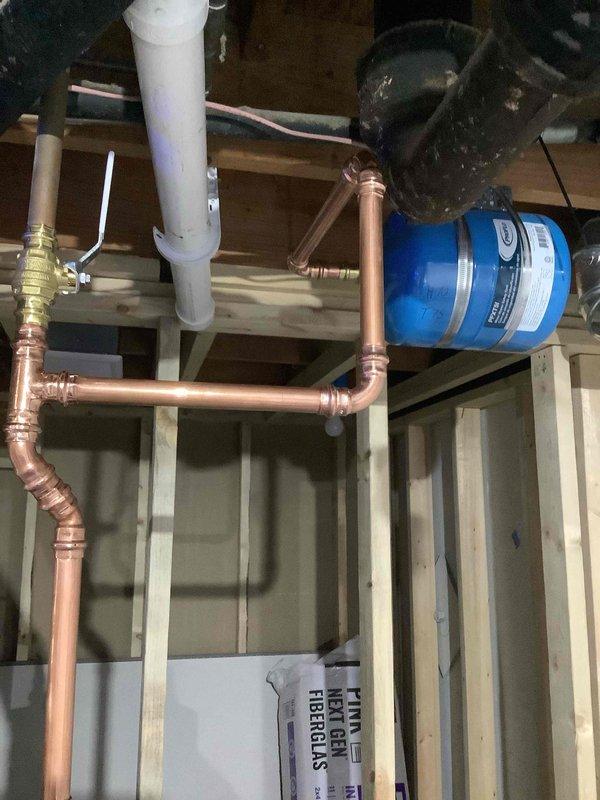Installed 50-gallon State ProLine gas water heater as part of full system installation under permit #26PLU-07650. Completed all copper supply line connections, integrated water treatment system with blue filter housing, and installed required safety components including pressure relief valve and gas supply connections. Applied required plumbing identification sticker and verified all connections for proper operation and code compliance.