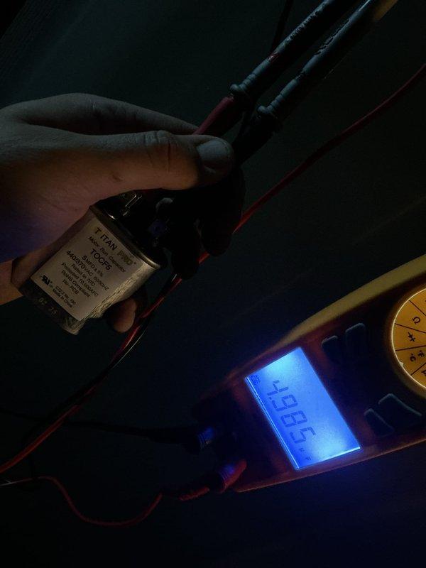 Responded to no cooling call on 5-year-old outdoor unit. Upon arrival, system was completely non-operational with no power to the unit. Performed diagnostic testing and identified failed dual run capacitor as the root cause. Tested capacitor with digital multimeter, confirming readings were out of specification and preventing compressor and condenser fan motor from starting. Replaced defective capacitor with properly rated replacement unit. Verified system startup, confirmed proper amperage draws on both compressor and fan motor, and restored full cooling operation to the system.