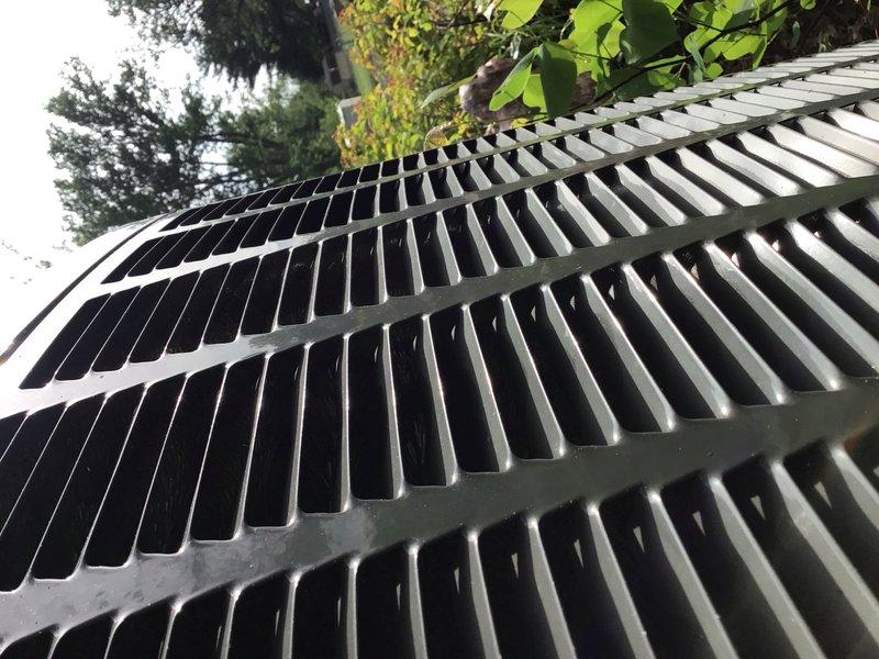 Completed preventive maintenance tune-up on a 4-year-old ground-mounted cooling unit. Removed top panel to access internal components, inspected evaporator coil assembly and refrigerant lines for proper condition, and noted accumulation of dirt and debris on coil fins requiring attention. Verified all accessible components, checked system operation, and ensured unit was secured upon completion of service.