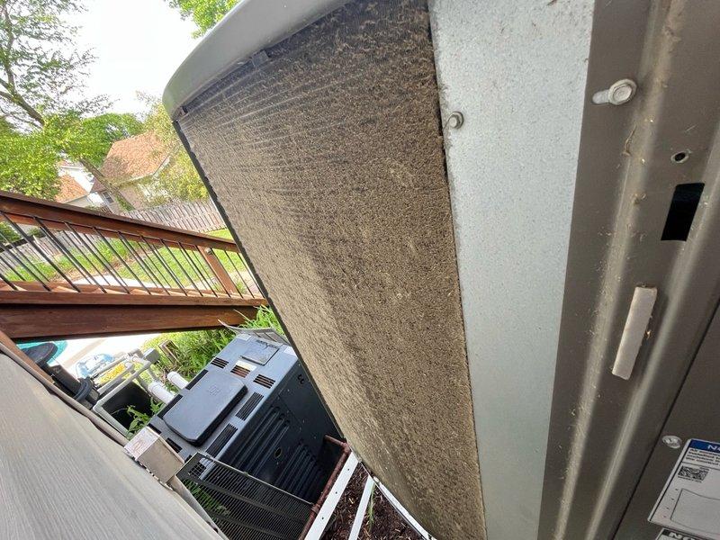 Completed annual cooling maintenance tune-up on residential HVAC system. Inspected outdoor condenser unit, noting significant dirt and dust accumulation on cooling fins and filter surfaces; cleaned and serviced unit to restore optimal airflow and efficiency. System tested and verified operational upon completion.