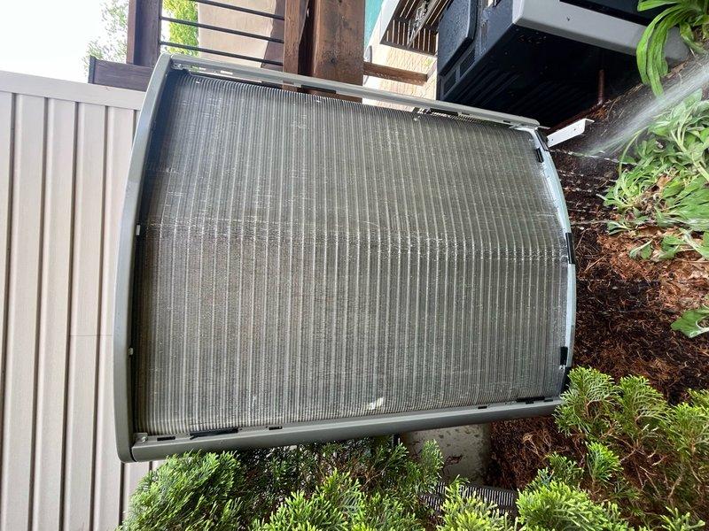 Completed annual cooling maintenance tune-up on residential HVAC system. Inspected outdoor condenser unit, noting significant dirt and dust accumulation on cooling fins and filter surfaces; cleaned and serviced unit to restore optimal airflow and efficiency. System tested and verified operational upon completion.