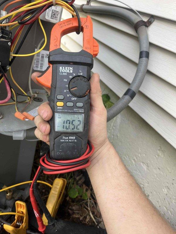 Completed comprehensive cooling season tune-up on 13-year-old outdoor condensing unit. Removed top panel to access internal components, inspected condenser coil condition and copper refrigerant lines for wear and leaks, verified compressor mounting and electrical connections, and performed amperage draw testing using clamp meter to assess system performance. Unit operational with all measurements within acceptable parameters.
